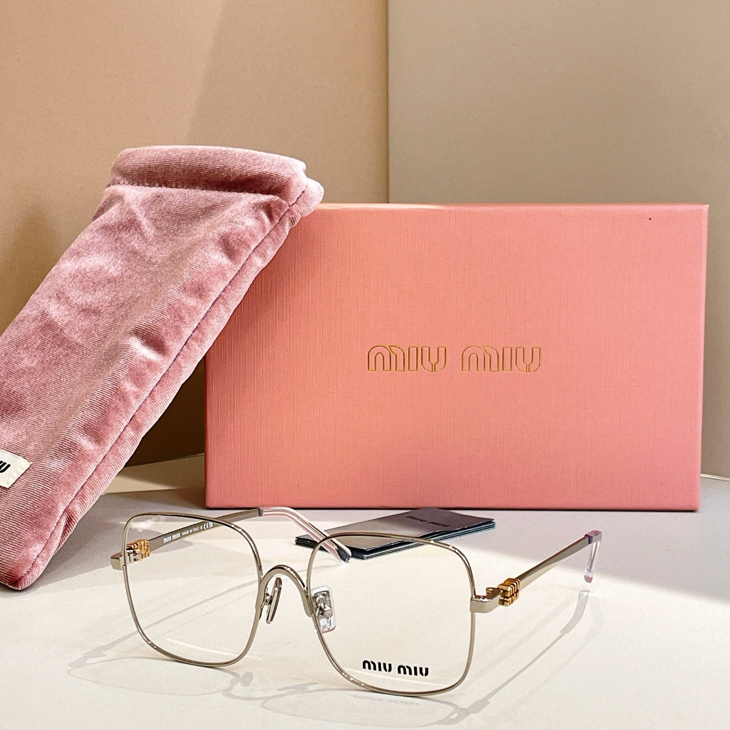 Gold and silver eyeglass frames with blue temple accents and clear lenses