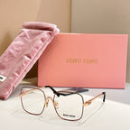 Gold metal eyeglass frames with dark temple accents and clear lenses