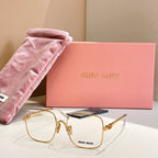 Gold metal eyeglass frames with blue temple accents and clear lenses