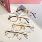Set of gold eyeglass frames with blue temple accents and clear lenses