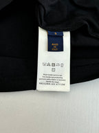 Louis Vuitton T-shirt care label close-up: Made in Italy and wash instructions.