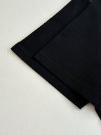 Louis Vuitton T-shirt lower side and hem close-up in black with stitched seam.