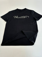 Louis Vuitton T-shirt, black with script logo on chest; laid flat with folded hem.
