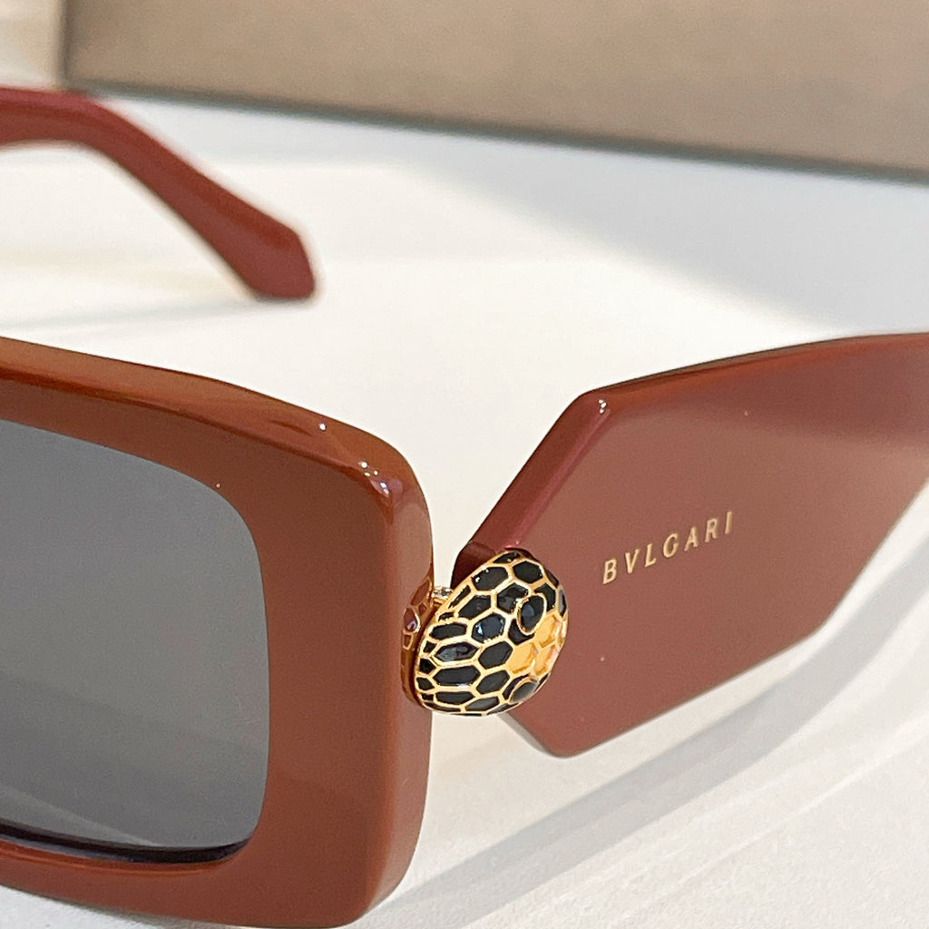 Brown square sunglasses closeup showing gold emblem and Bvlgari on lens arm