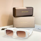 White square sunglasses with tinted pink lenses and gold logo temple detail