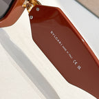 Brown square sunglasses closeup with gold emblem at temple and Bvlgari logo