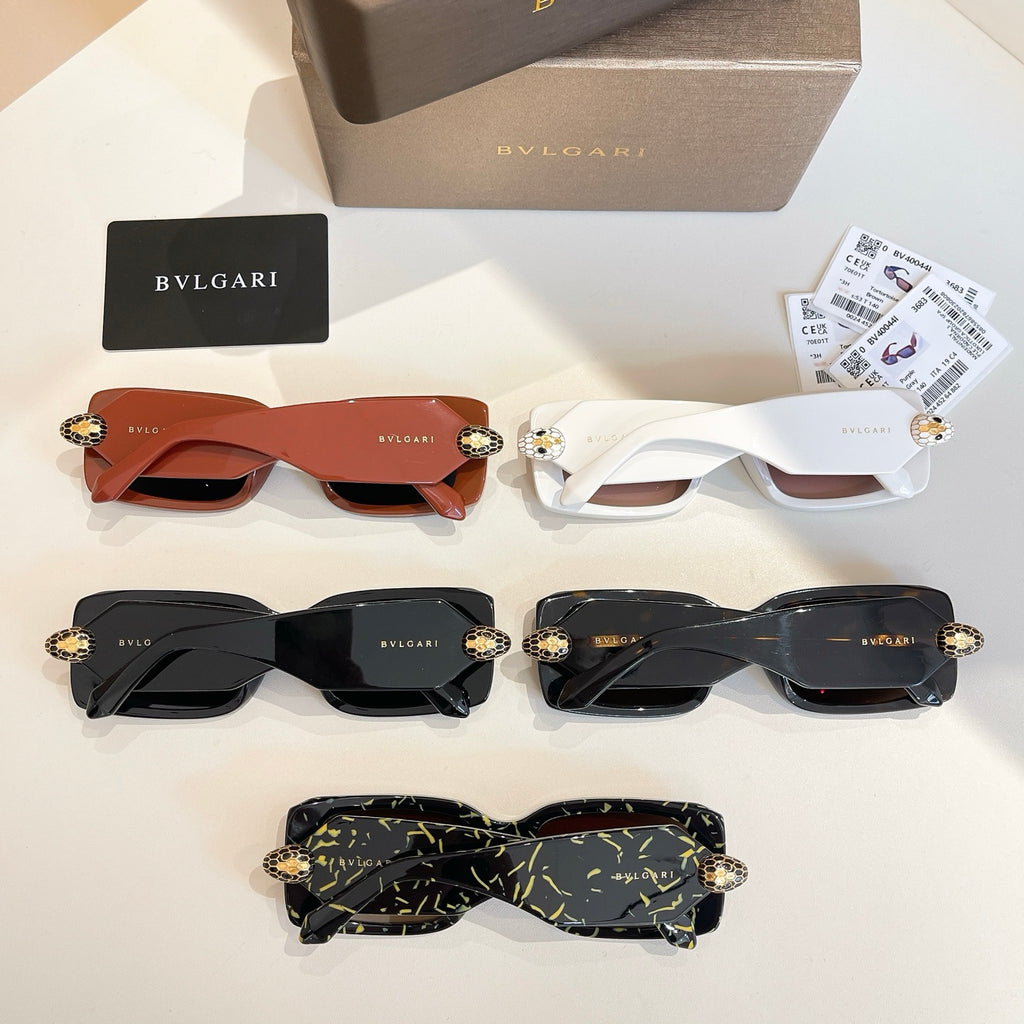 Assorted sunglasses: orange, white, black, and green patterned frames with gold emblems