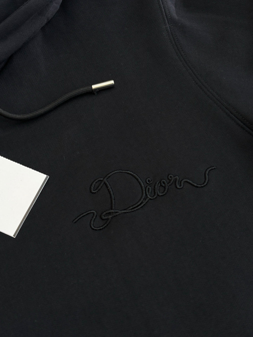 Dior hoodie in black with embossed Dior script logo on the chest