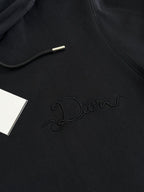 Dior hoodie in black with embossed Dior script logo on the chest