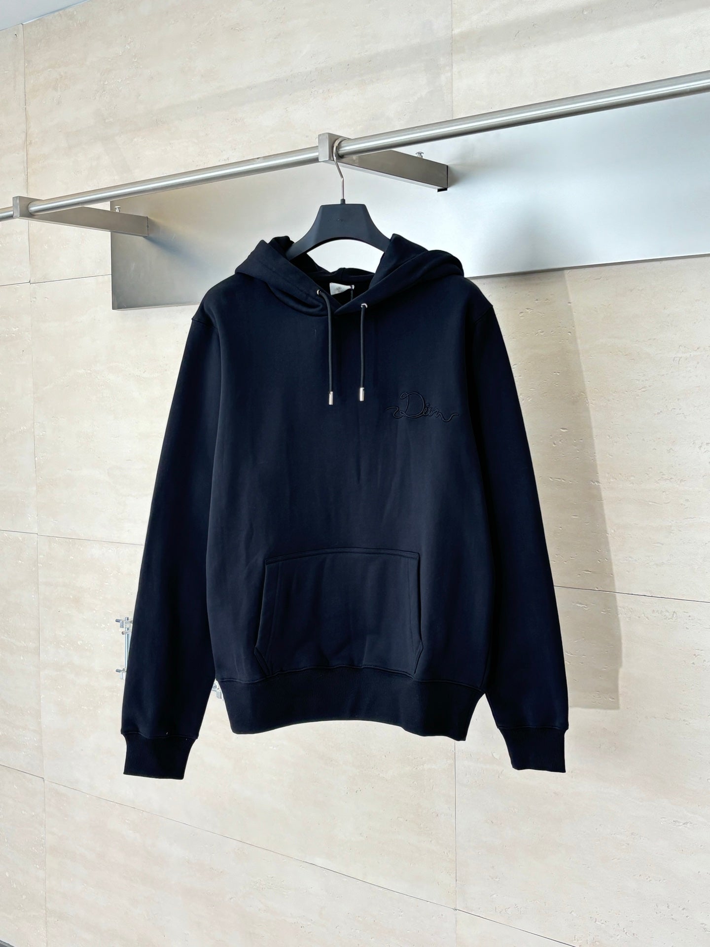 Dior long-sleeve hoodie in dark navy with hood, drawstrings, and front kangaroo pocket