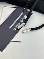 Dior hoodie drawstring and care tag detail on black fabric