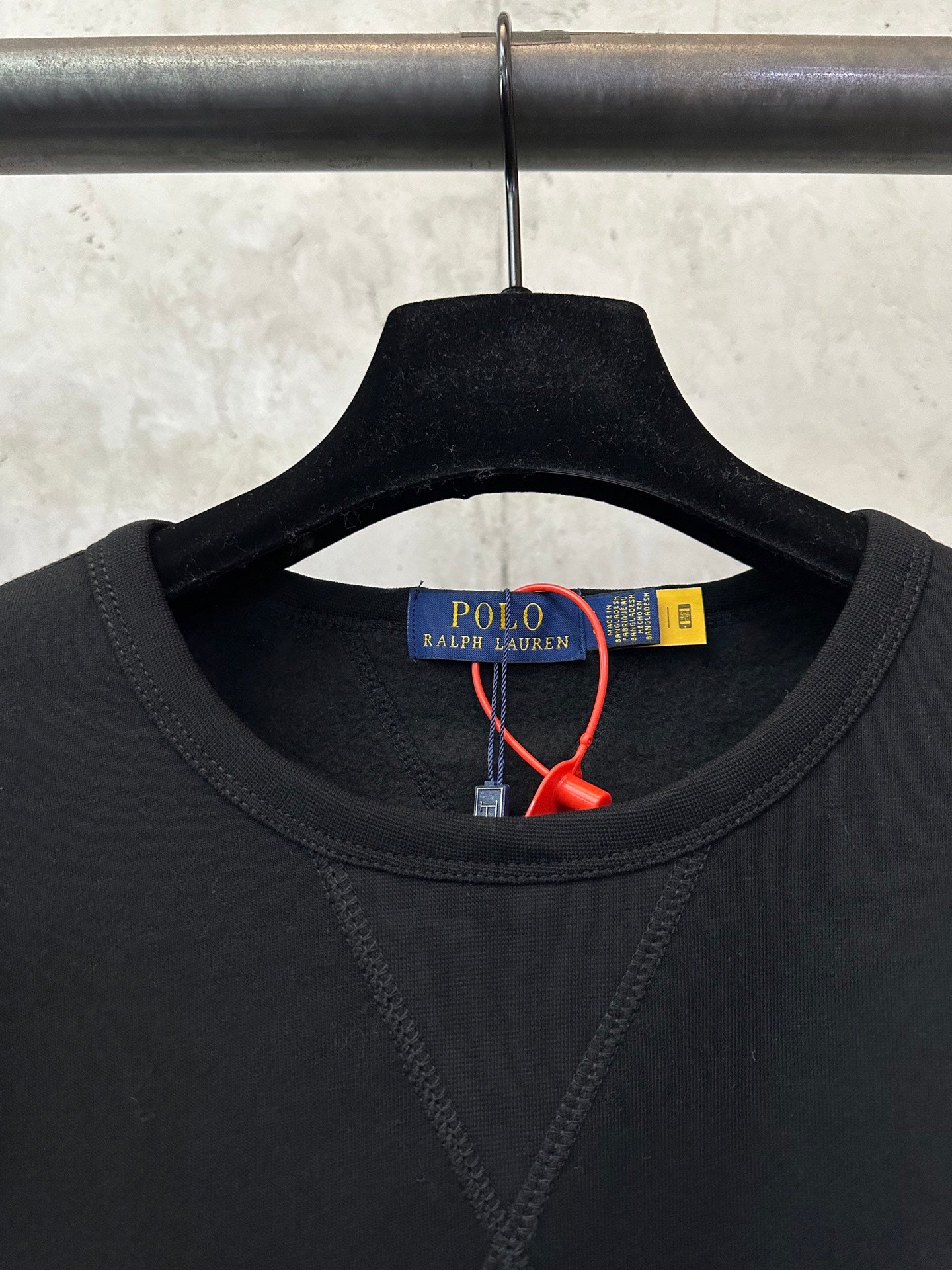 Black crewneck sweatshirt neckline detail with Polo Ralph Lauren label