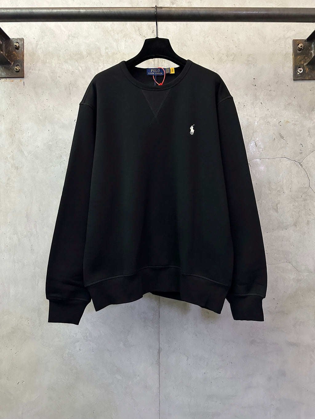 Black crewneck sweatshirt with small Polo logo on the left chest