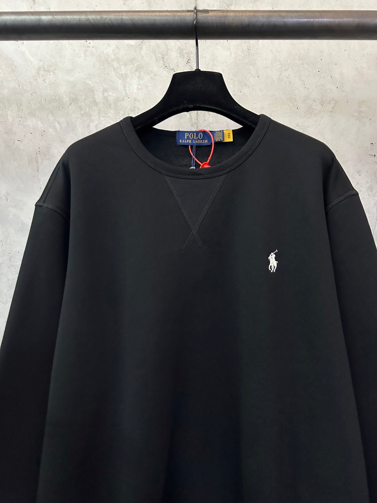 Black crewneck sweatshirt with Polo Ralph Lauren logo on the left chest