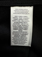 Care label on black sweatshirt: made in Bangladesh, fabric and instructions