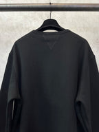 Black crewneck sweatshirt back view with diagonal shoulder seam