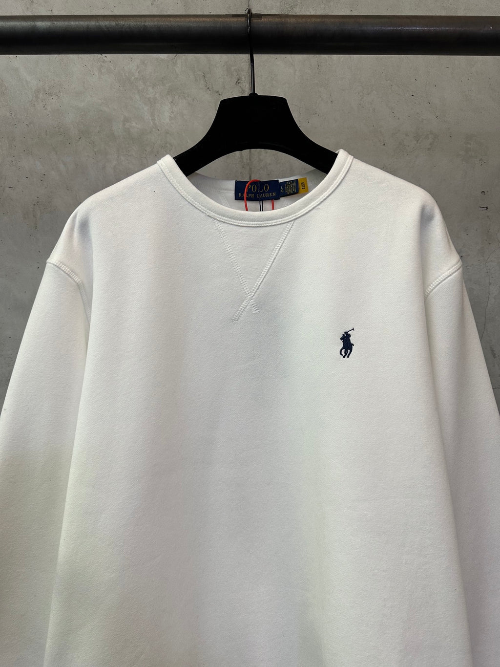White crewneck sweatshirt with small navy Polo player logo on chest