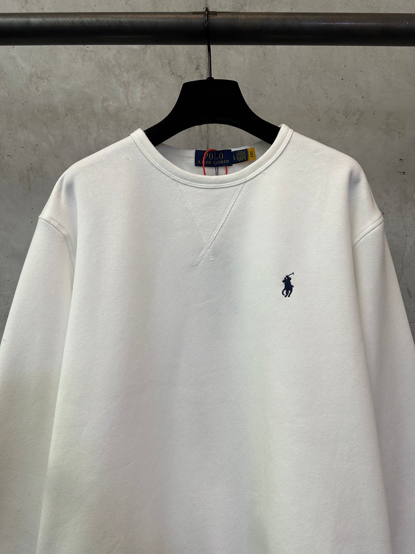 White crewneck sweatshirt with small navy Polo player logo on chest