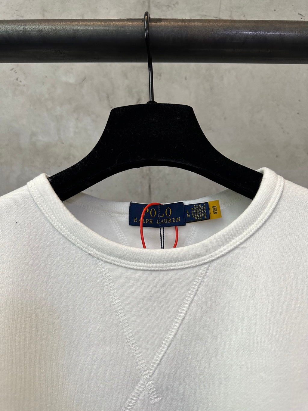 White crewneck sweatshirt neckline with inner neck label visible