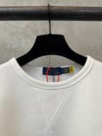 White crewneck sweatshirt neckline with inner neck label visible