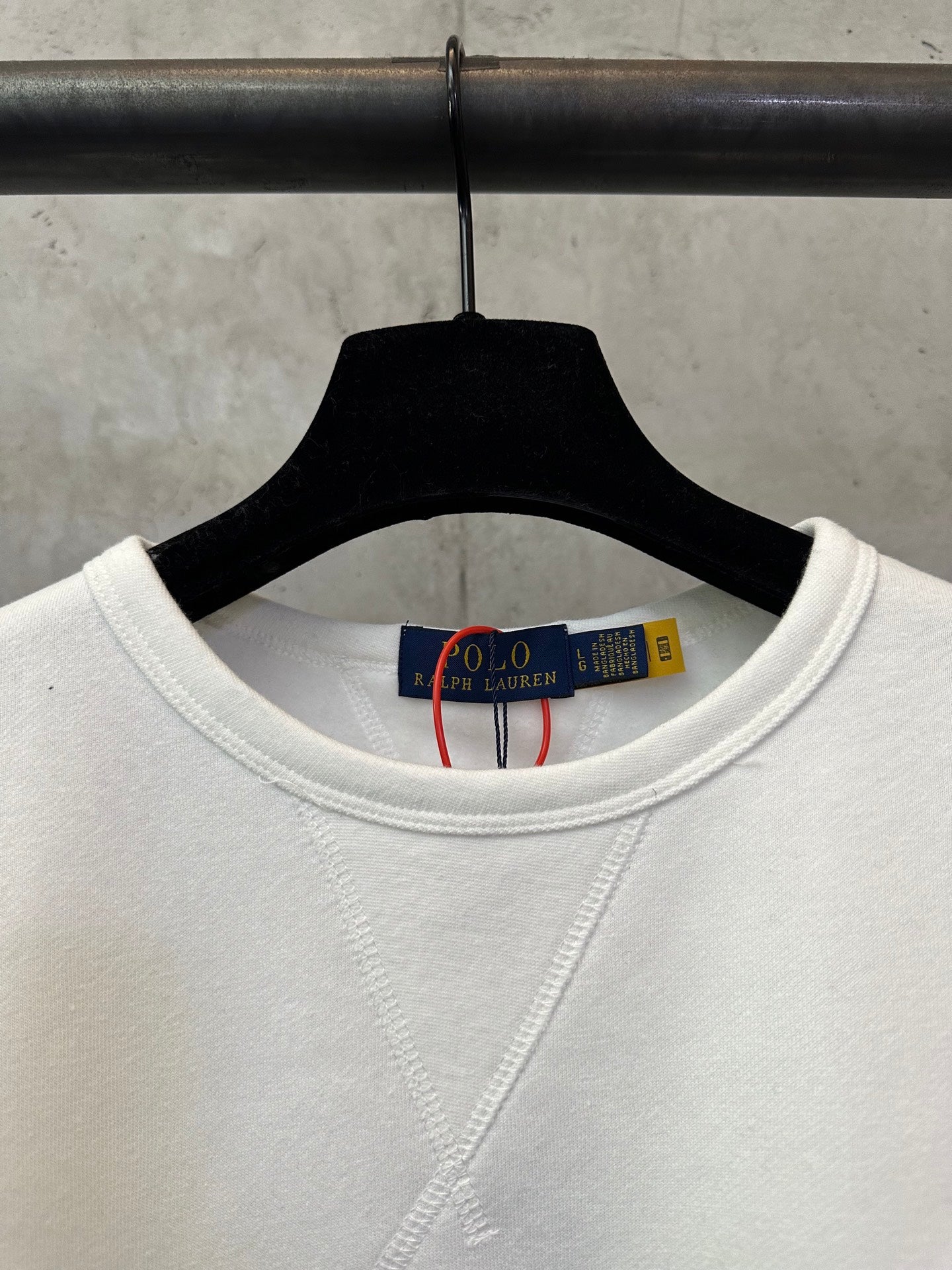 White crewneck sweatshirt neckline with inner neck label visible