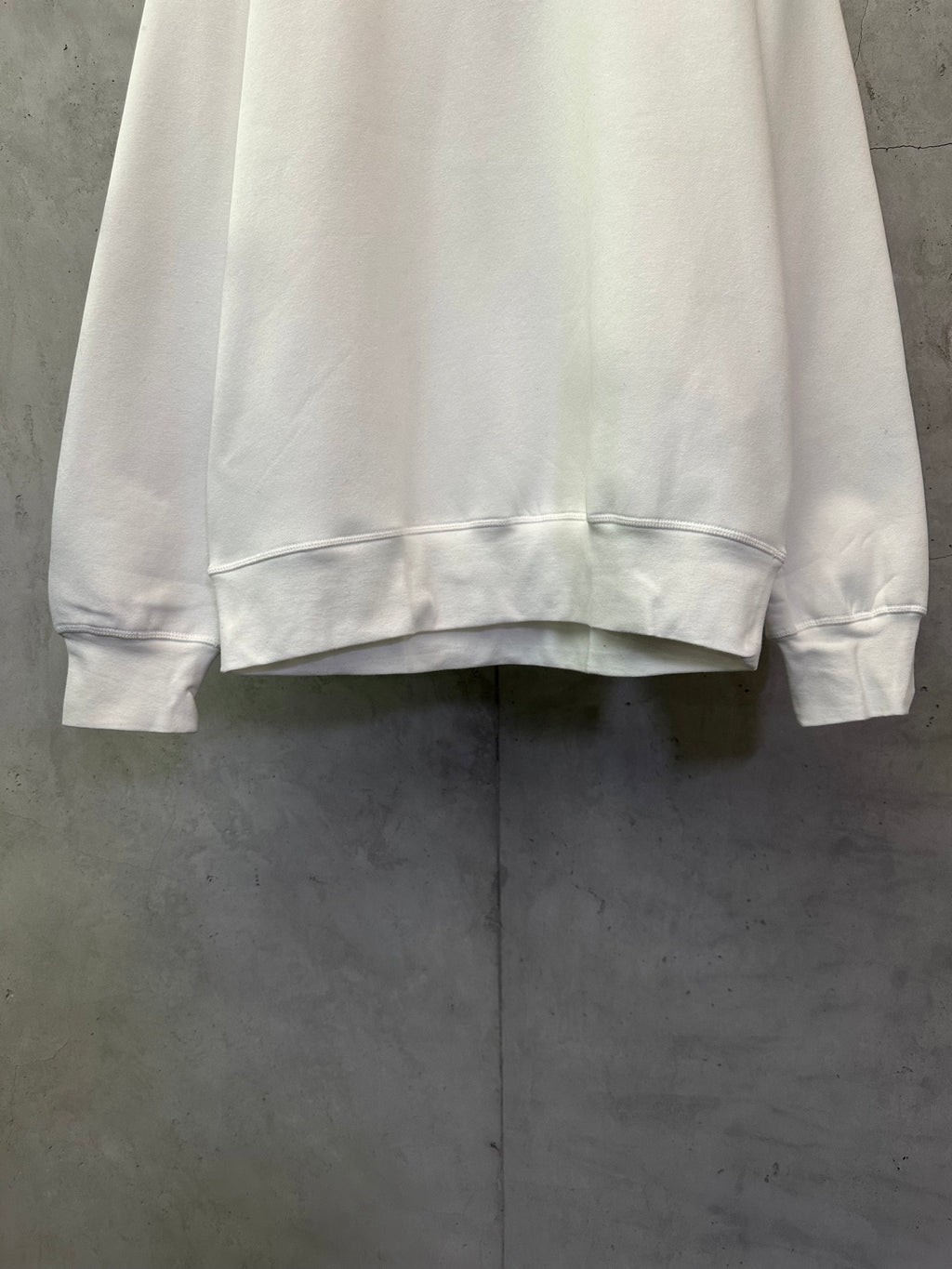 White crewneck sweatshirt hem and cuffs