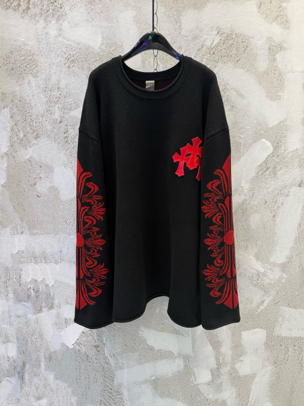 Black long-sleeve shirt with red cross applique and red patterned sleeve panels