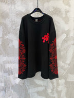 Black long-sleeve shirt with red cross applique and red patterned sleeve panels