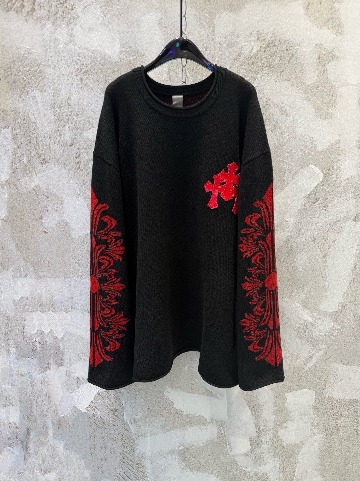 Black long-sleeve shirt with red cross applique and red patterned sleeve panels