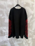 Black long-sleeve shirt with red patterned sleeve panels