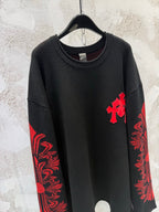 Black long-sleeve shirt with red cross chest detail and red sleeve design