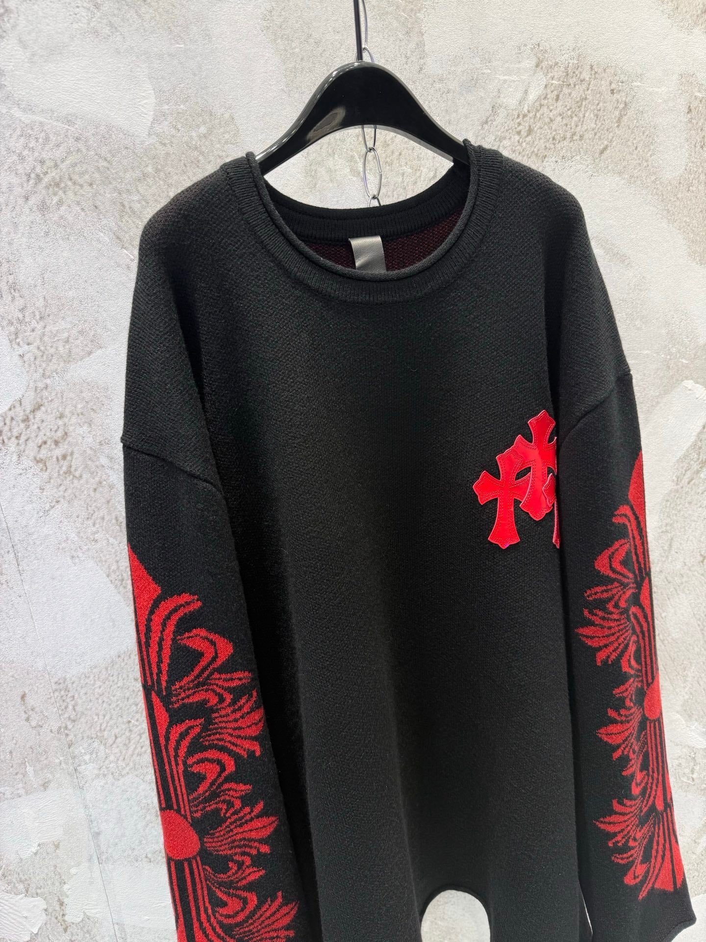 Black long-sleeve shirt with red cross chest detail and red sleeve design