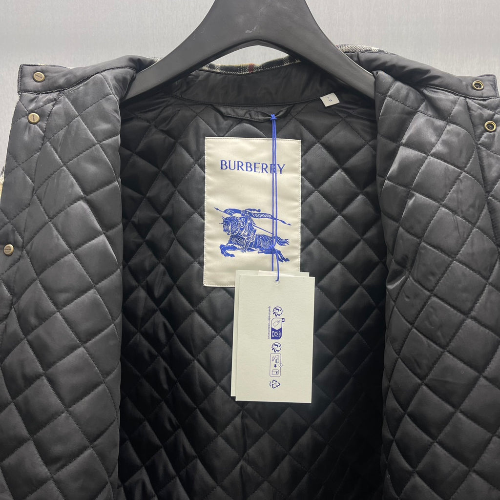 Quilted Burberry jacket with black diamond stitching and paper brand tags