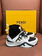White and black high-top sneakers with black sock collar, laces, and thick sole