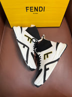 White and black high-top sneakers with black laces and gold-toned side lettering