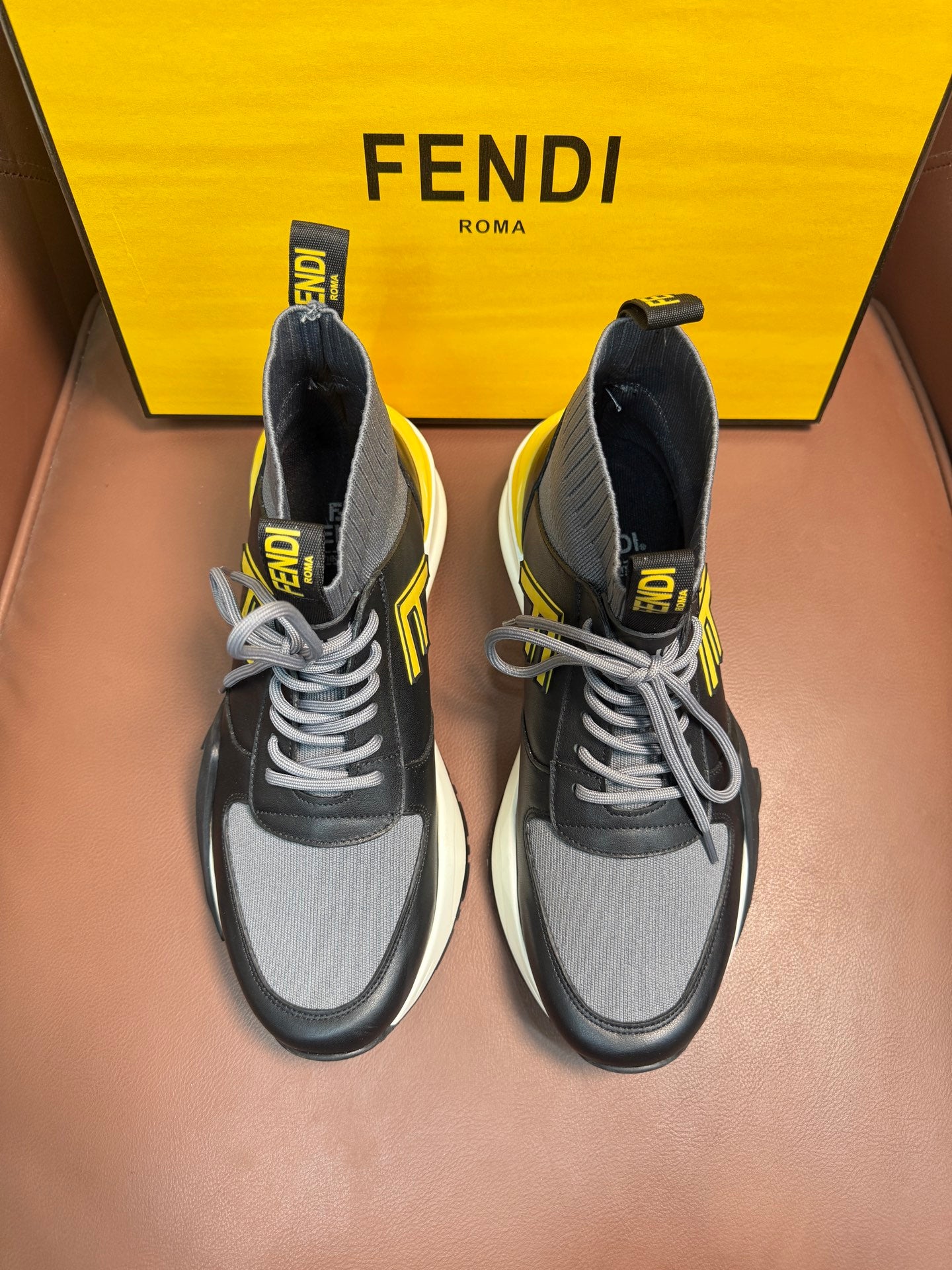 Fendi unisex sneakers in dark gray with yellow logo accents and white soles