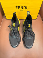 Pair of high-top sneakers in dark gray with neon yellow logo accents and chunky sole