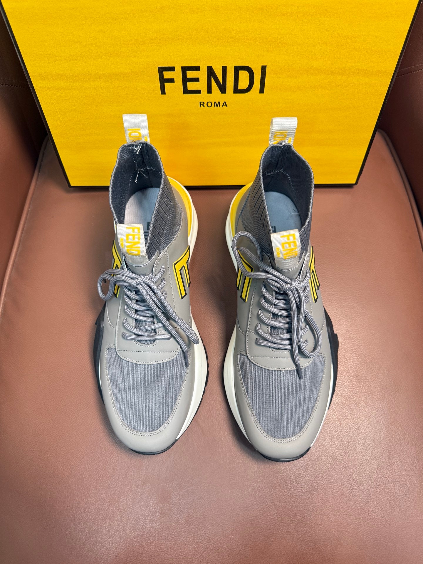 Fendi unisex sneakers in light gray with yellow logo accents and white soles
