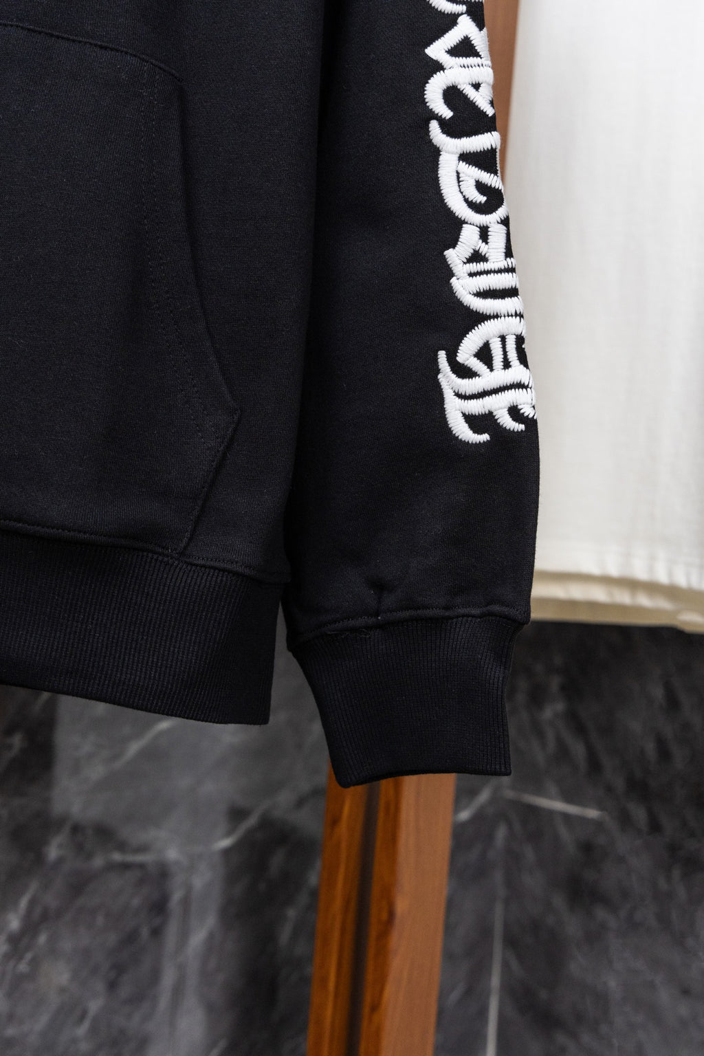 Black hoodie hem and sleeve cuff with ribbed trim