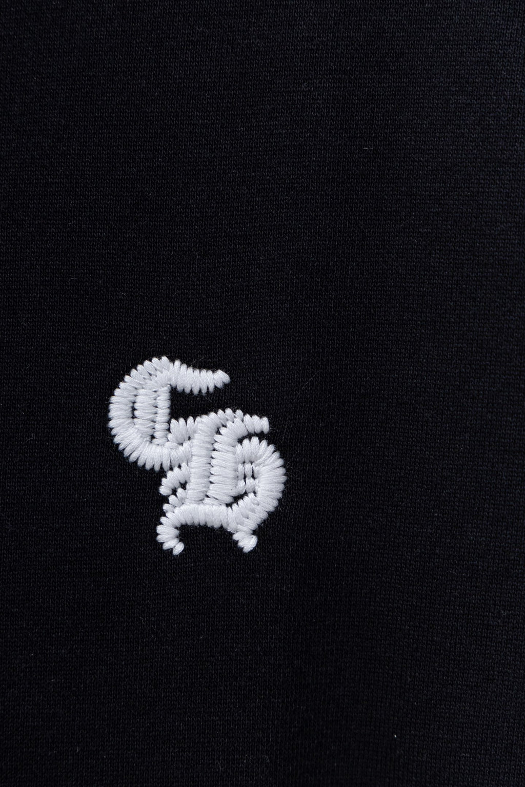 Black hoodie with small white heart logo embroidery on chest