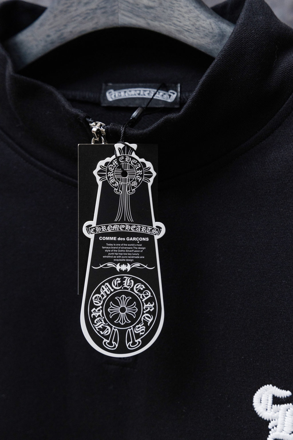 Black hoodie collar with brand tag and hanging size tag