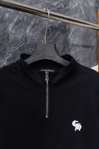 Black zip-up hoodie front with silver zipper and small white chest logo