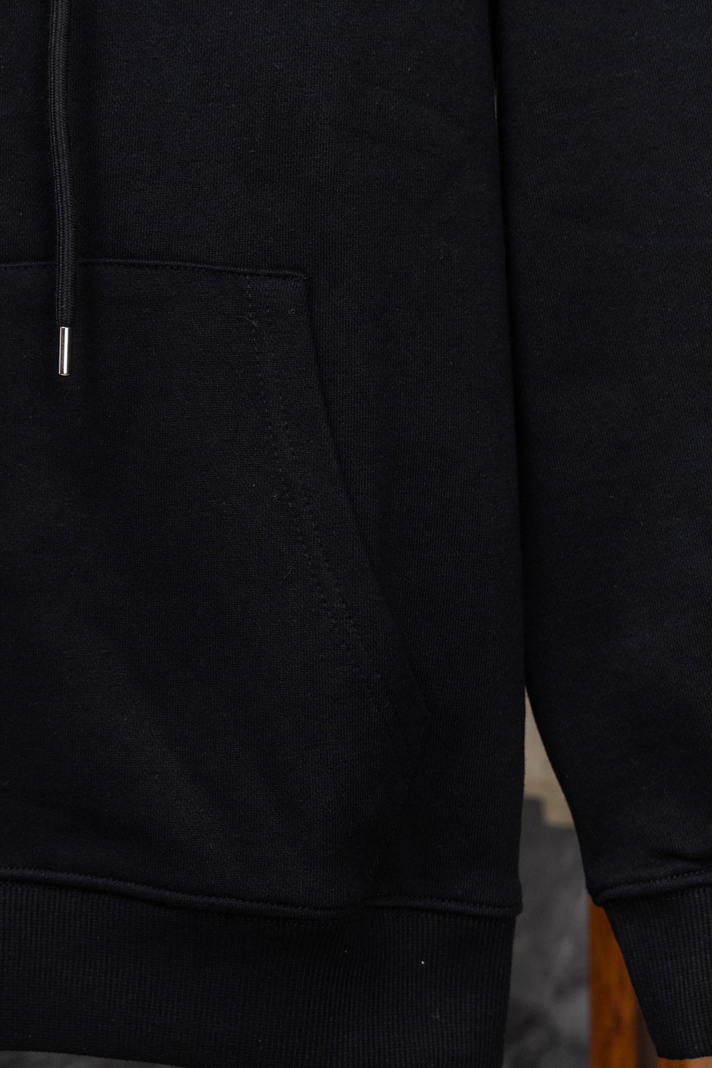 Black hoodie sleeve and side pocket with ribbed cuff