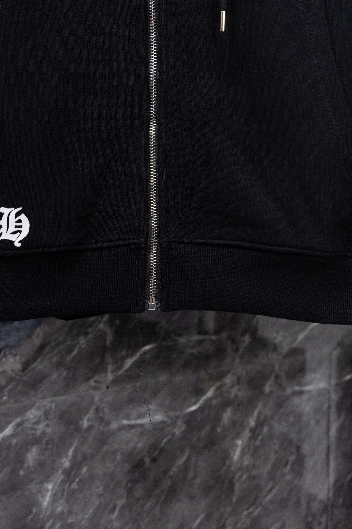 Black hoodie front zipper with ribbed hem and drawstring area