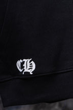 Black hoodie cuff with white logo embroidery near hem