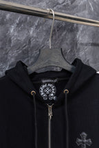 Black zip-up hoodie on hanger with hood and cross front embroidery