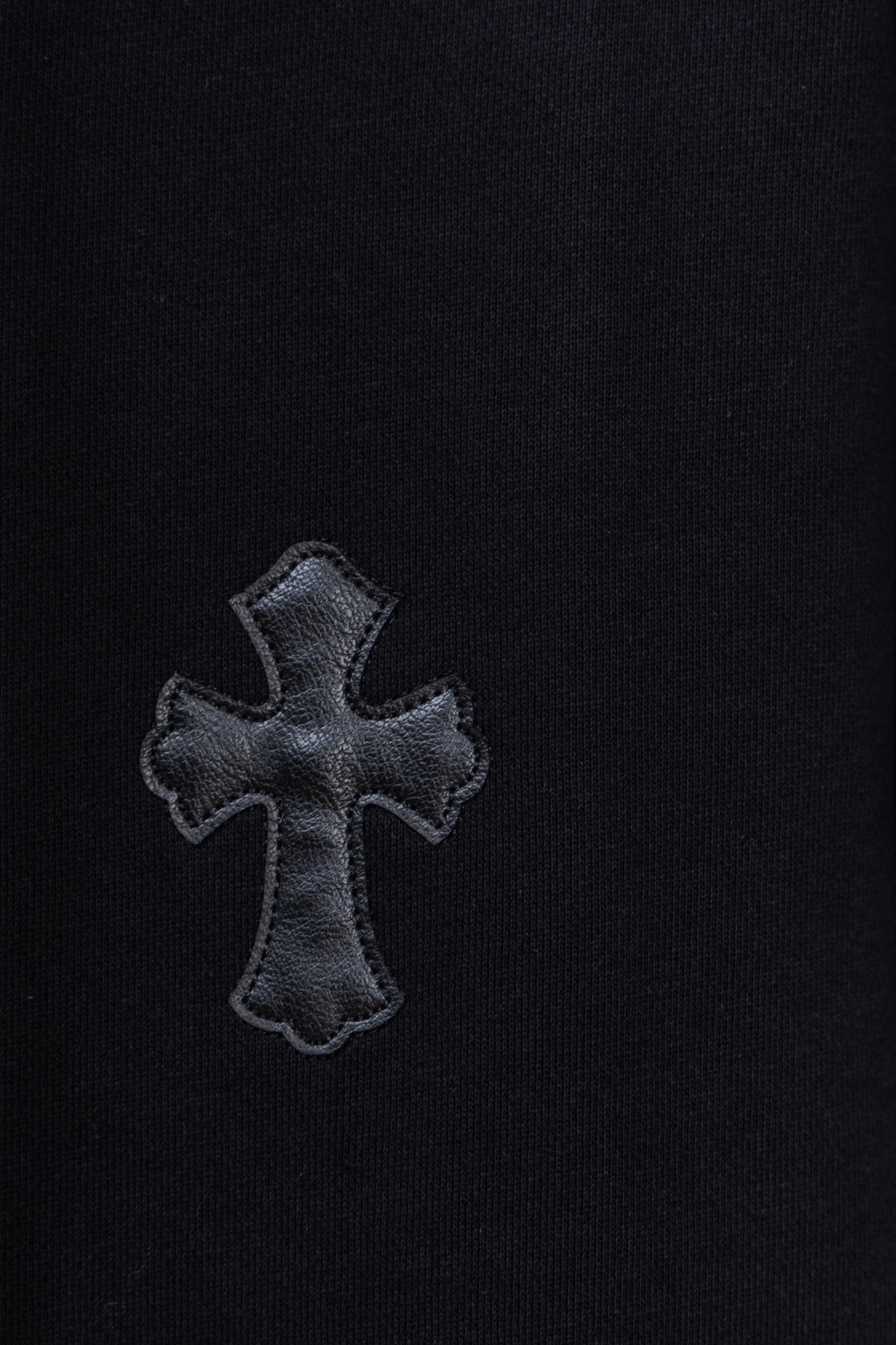 Black hoodie with embroidered cross patch on chest