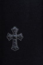 Black hoodie with embroidered cross patch on chest
