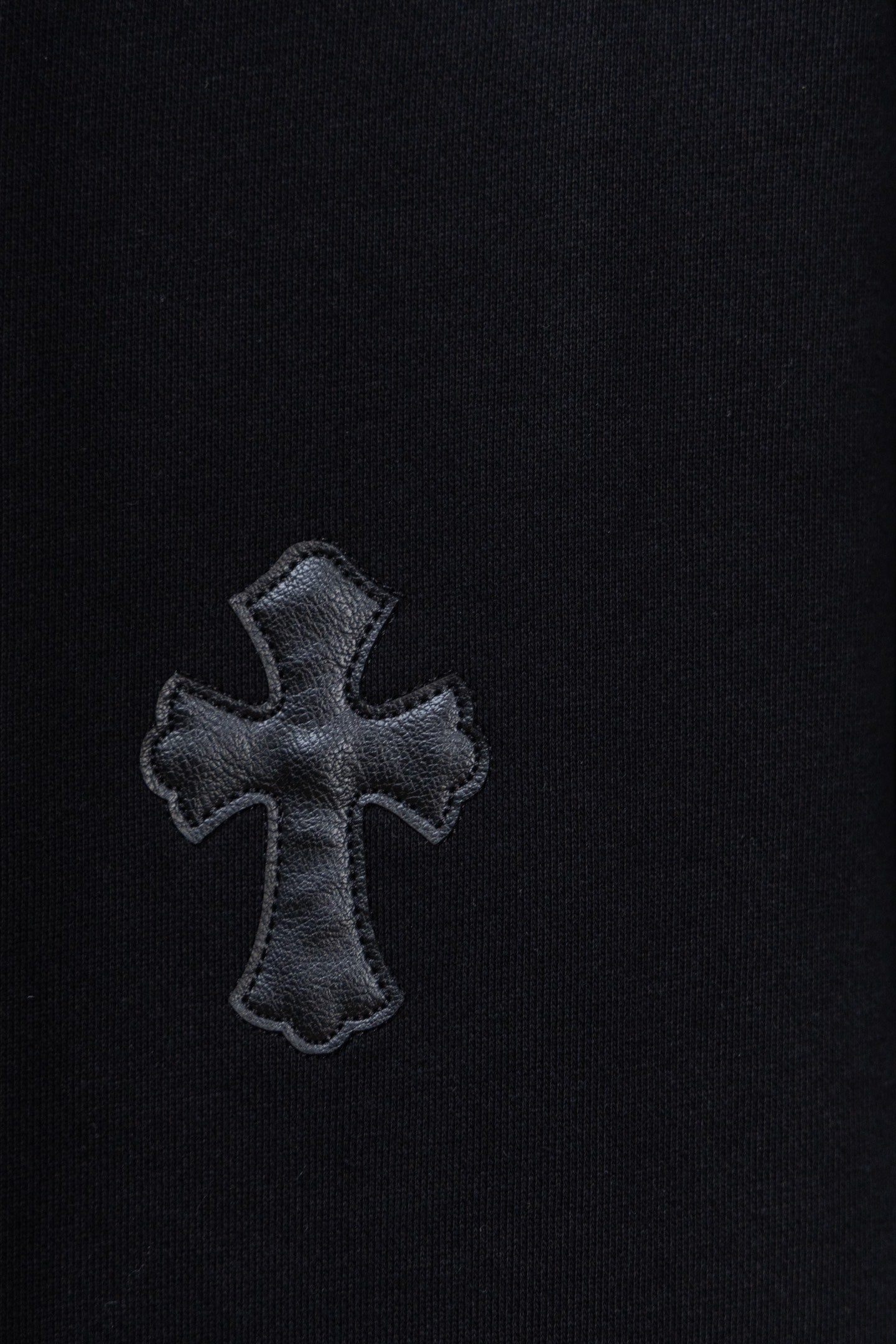 Black hoodie with embroidered cross patch on chest