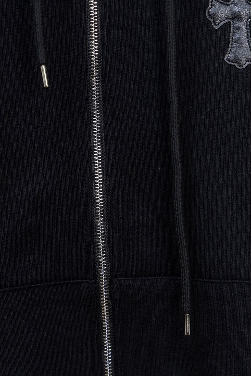 Dark zip-up hoodie front with silver zipper